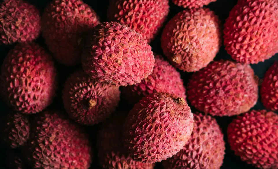 a pile of red fruit sitting on top of a table