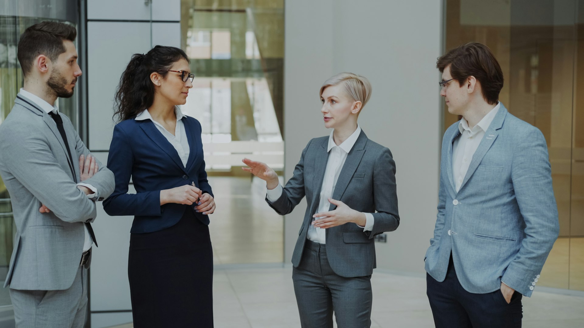 Four business professionals in a meeting discussing ideas.
